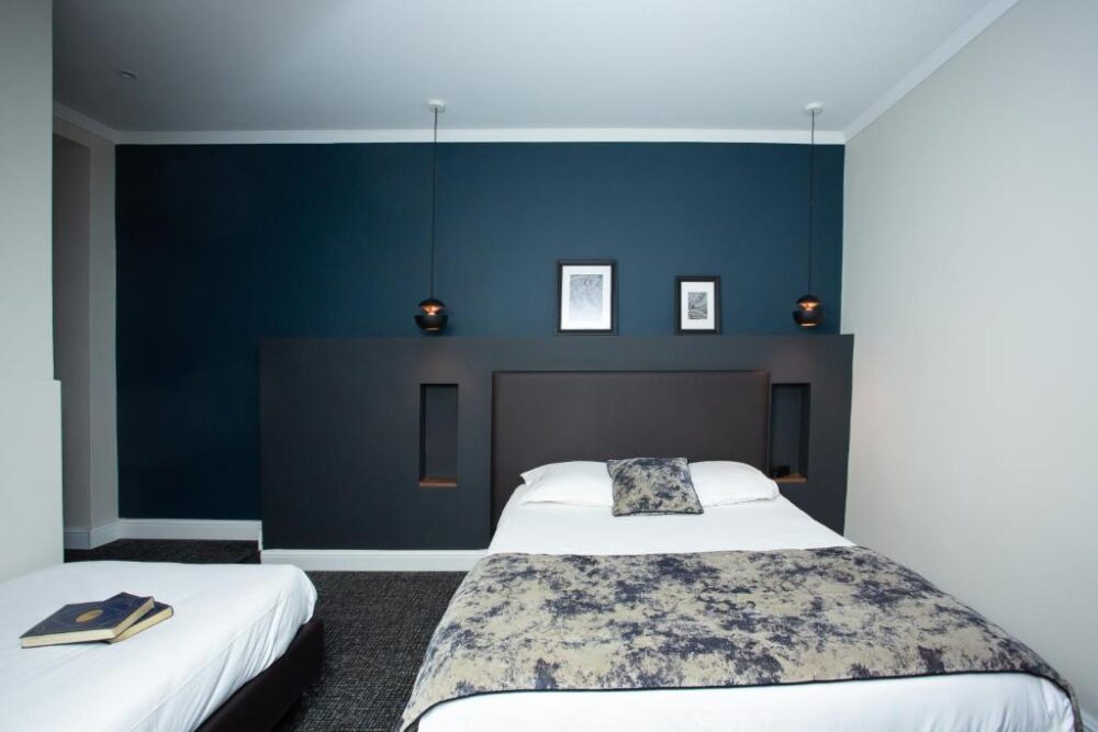 Chambre moderne avec grand lit et décoration bleue