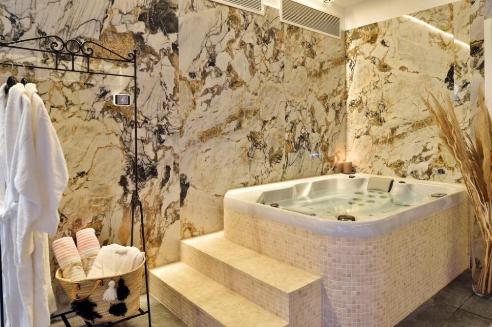 Jacuzzi luxueux dans salle de bain en marbre.