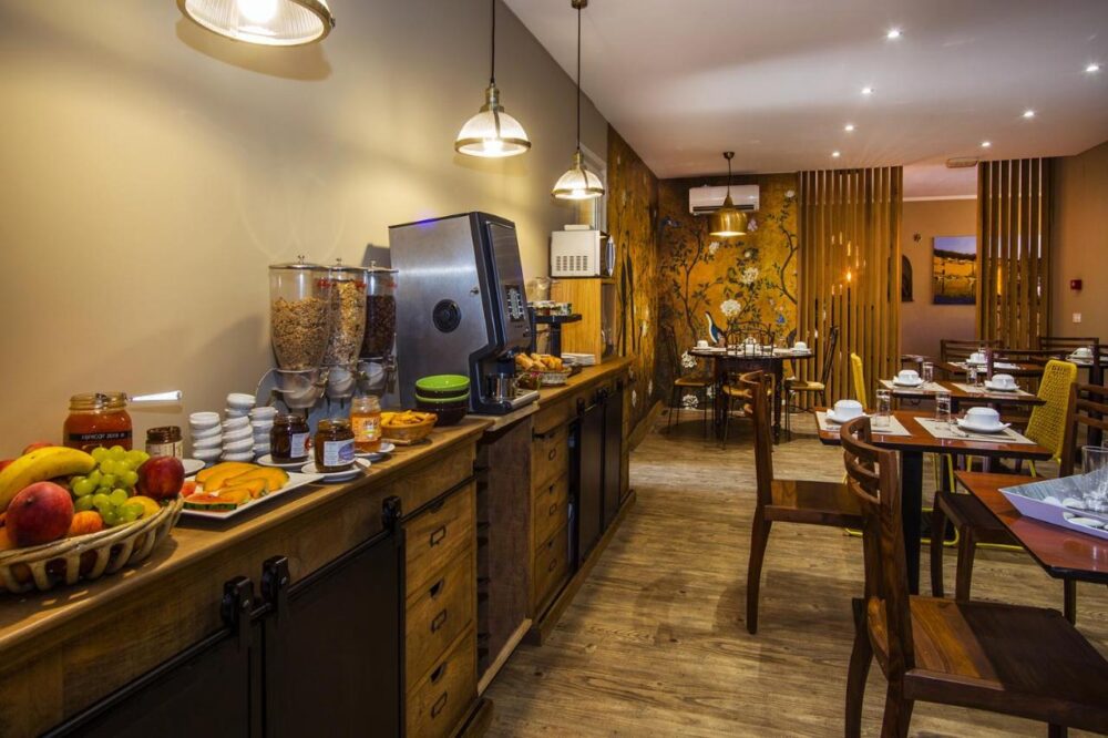 Salle de petit-déjeuner avec buffet varié.