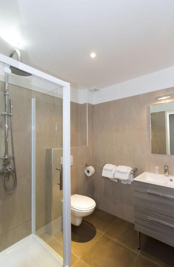 Salle de bain moderne avec douche et lavabo.