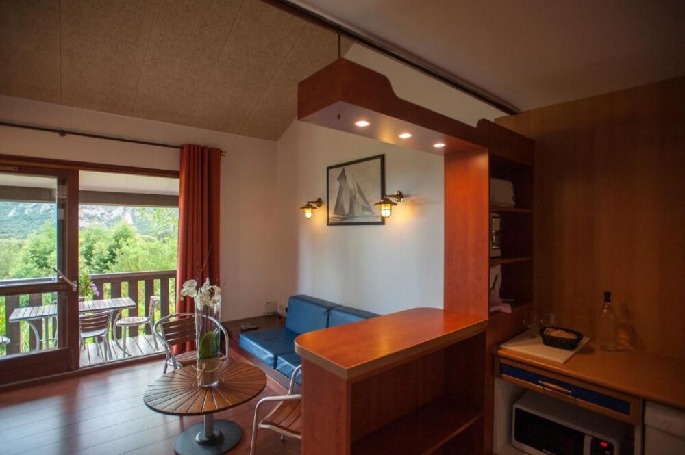 Salon avec vue sur balcon et montagne.