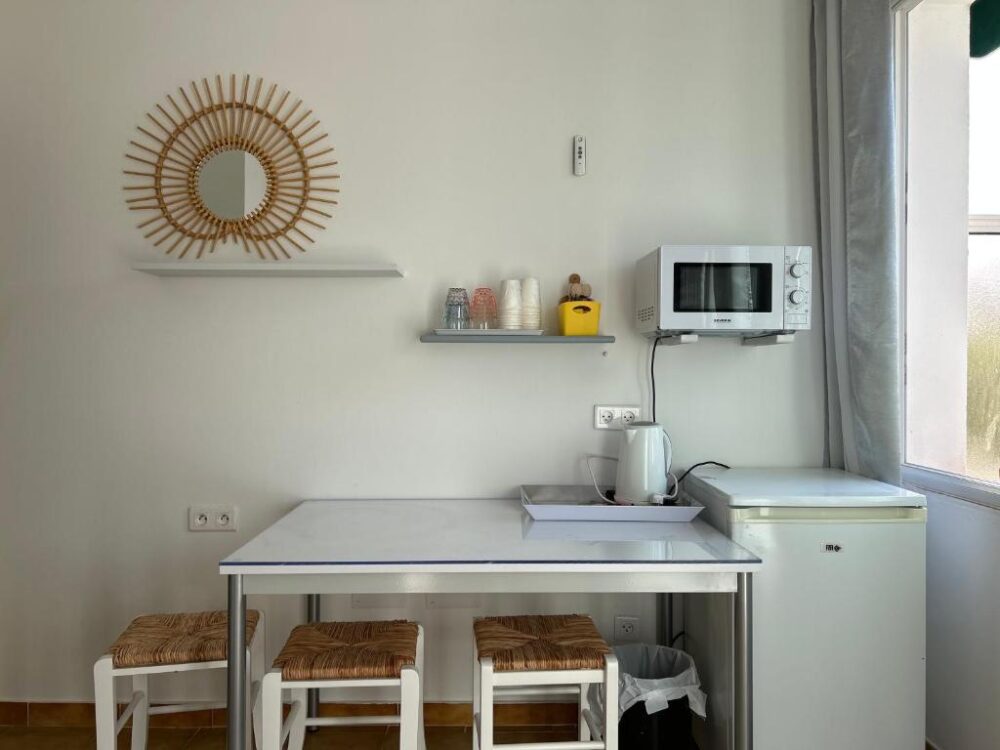 Petite kitchenette avec micro-ondes et table.