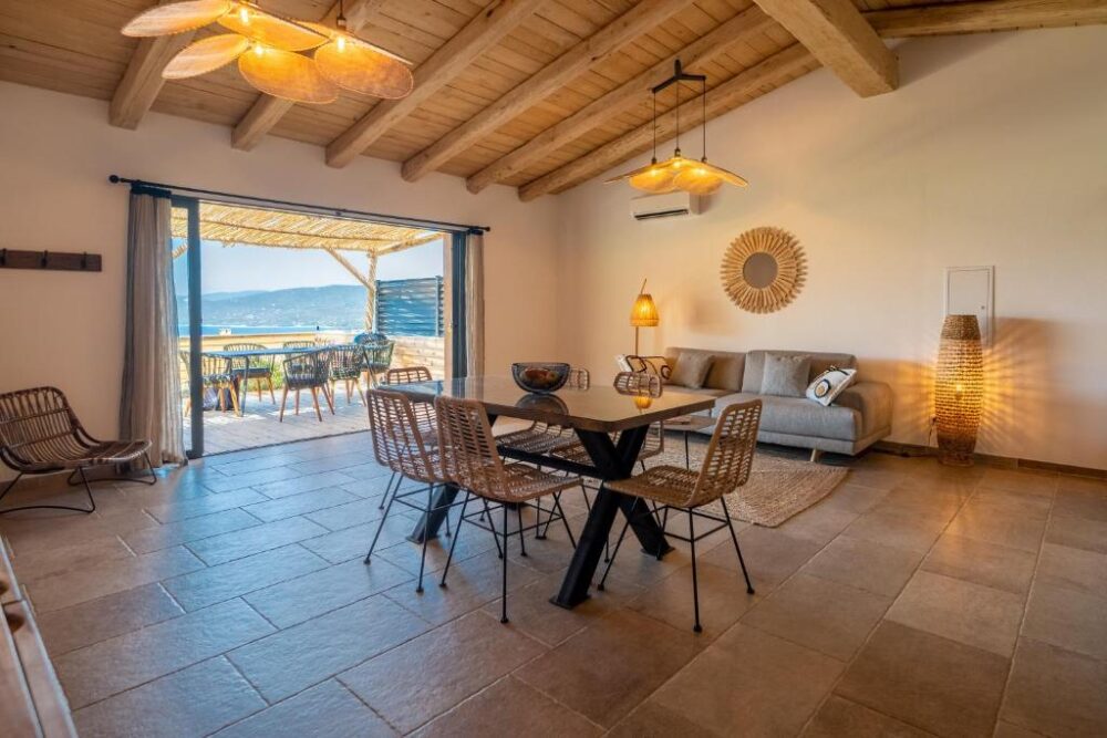 Salon ouvert avec vue sur terrasse ensoleillée.