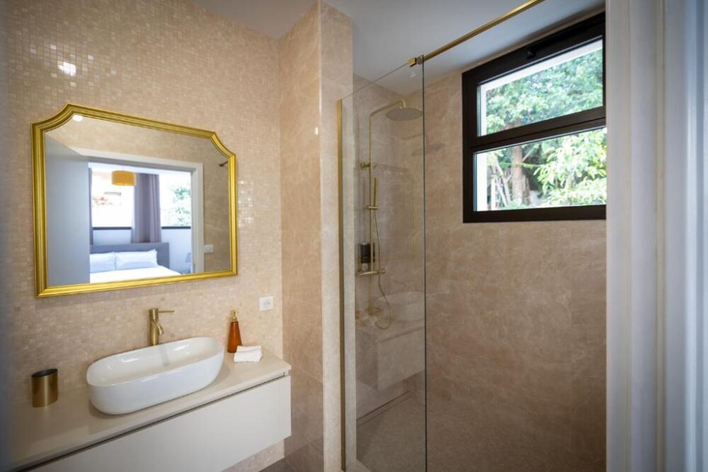 Salle de bain moderne avec douche et lavabo.